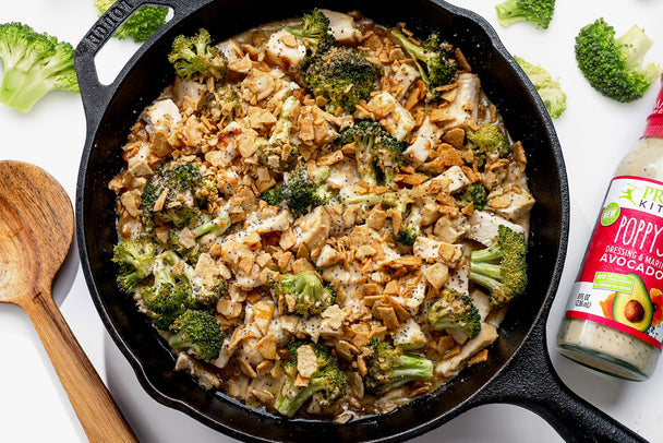 Poppy seed chicken and broccoli casserole made with delicious Primal Kitchen Poppyseed Dressing, in a cast iron skillet.