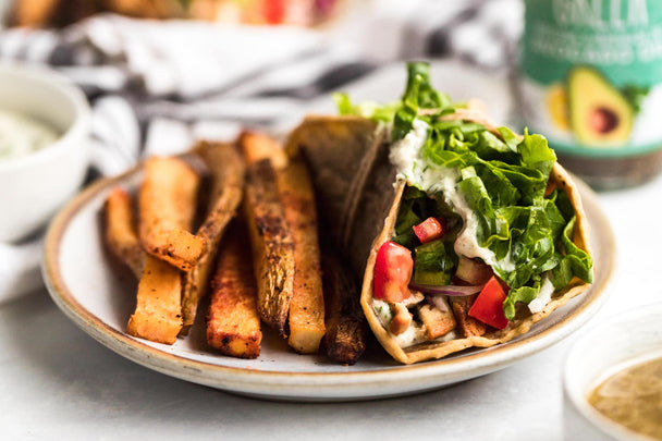 A chicken gyro made with Primal Kitchen Greek Dressing, on a plate.