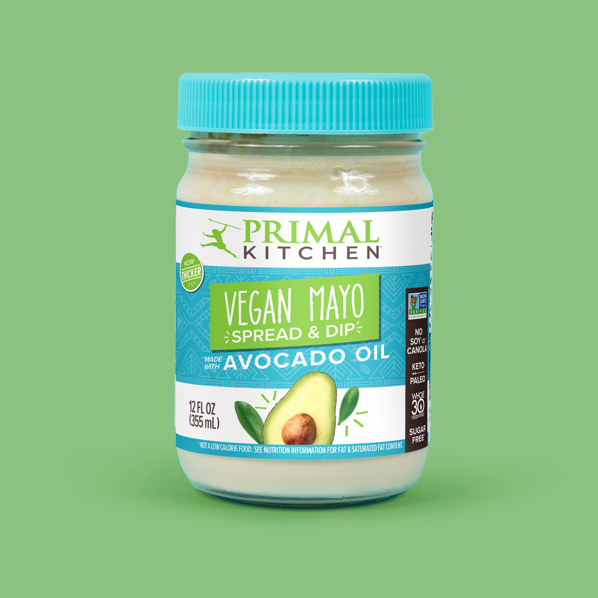 A 12 oz glass jar with a light blue lid of Primal Kitchen Vegan Mayo made with Avocado Oil against a green background.