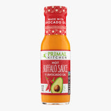 Bottle of Primal Kitchen Hot Buffalo Sauce made with Avocado Oil on white background