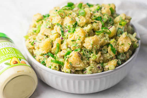 A bowl of creamy potato salad made with Primal Kitchen Mayo and Spicy Mustard. 
