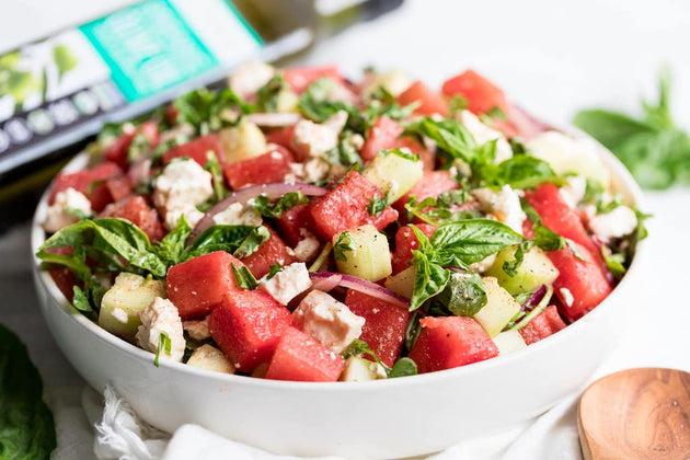 A bowl of Watermelon Feta Salad made with feta cheese, cucumbers, and fresh herbs.