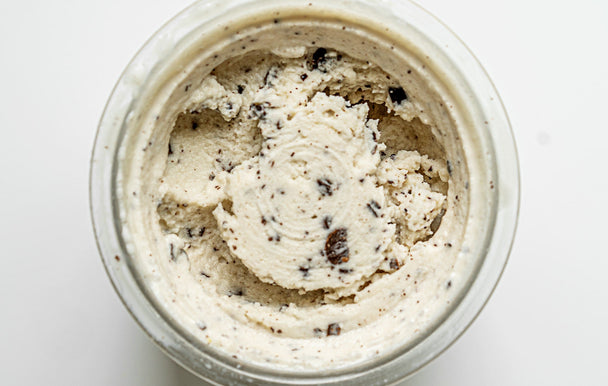 An overhead shot of vanilla chocolate chip collagen ice cream swirled in a Ninja CREAMi container. 