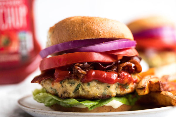 Closeup of a juicy chicken burger with all the fixings.