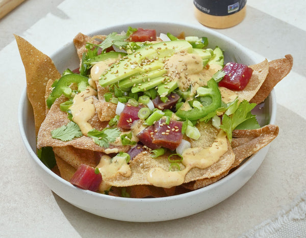 A bowl of poke nachos drizzled with Primal Kitchen Yum Yum Dipping Sauce.