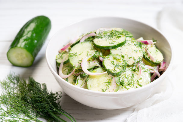 Creamy cucumber salad with ranch dressing, red onion, and dill.