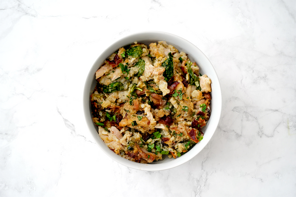Chicken bacon ranch casserole in a white bowl on a marble background.