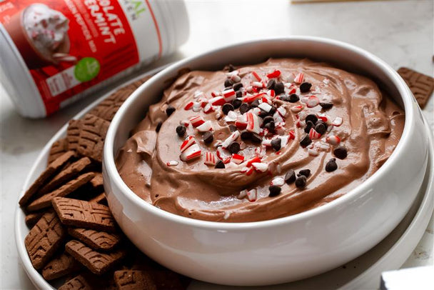 Brownie batter dip with chocolate cookies and peppermint sprinkles.