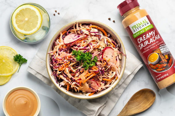 Bowl of prepared slaw with Primal Kitchen Creamy Sriracha Dipping Sauce