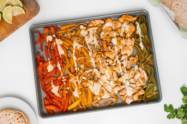 A sheet pan of chicken and vegetables for fajitas