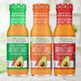 Three bottles of Primal Kitchen Mild and Sweet Buffalo Sauce, Original Buffalo Sauce made with Avocado Oil, and Hot Buffalo Sauce