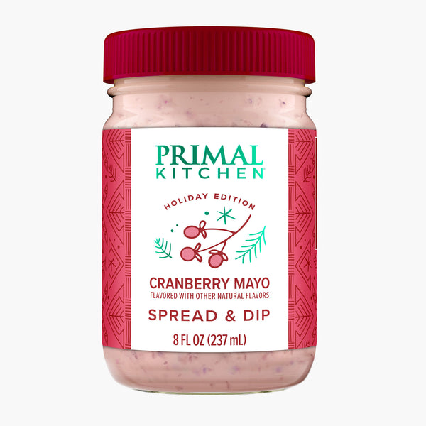 An 8 oz glass bottle with a red lid of Primal Kitchen Cranberry Mayo.