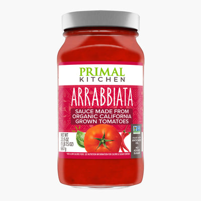 A jar of Primal Kitchen Arrabbiata Marinara Pasta Sauce made from organic California grown tomatoes with a red-pink label, on a light grey background. 