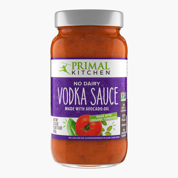 A jar of Primal Kitchen No Dairy Vodka sauce Made with Avocado Oil and Organic Tomatoes, with a purple label, on a light grey background.