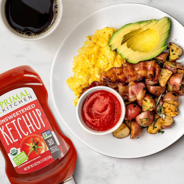 Unsweetened primal kitchen with a complete breakfast of eggs, potatoes, bacon and avocado.