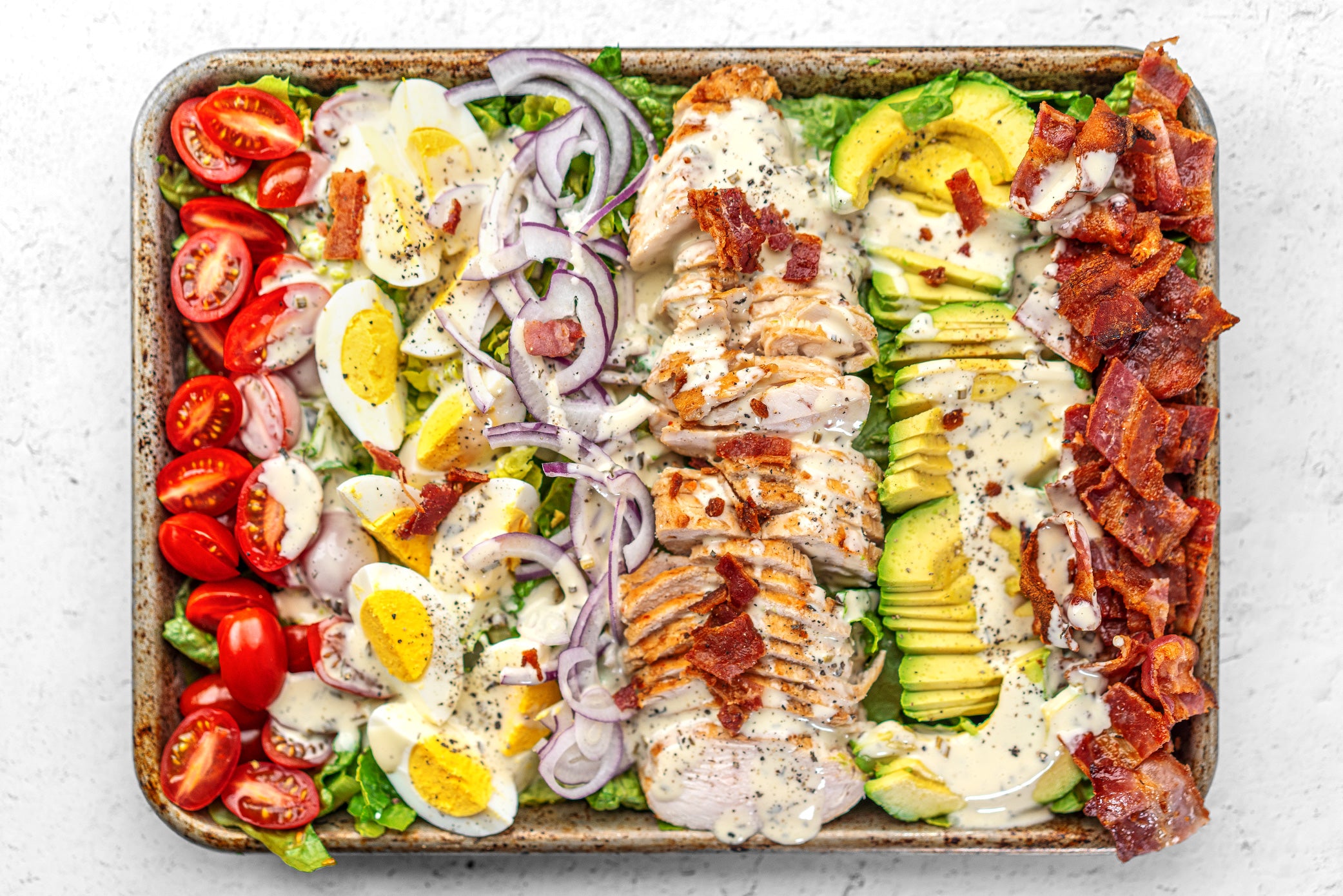 Sheet pan Keto Cobb Salad with Ranch Dressing Drizzled on top