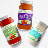 Jars of Primal Kitchen Tomato Basil Marinara Sauce, Primal Kitchen No Dairy Vodka Sauce Made with Avocado Oil, and Primal Kitchen No Dairy Alfredo Sauce on a light grey background.