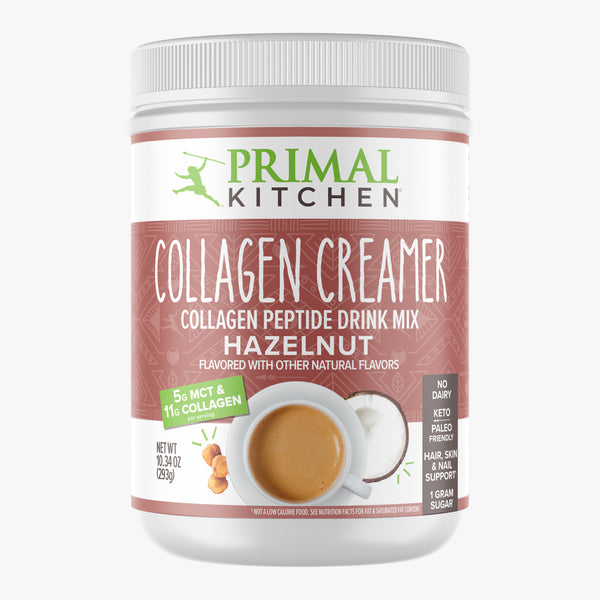 A canister of Primal Kitchen No Dairy Hazelnut Collagen Creamer  with a brown and white label on a light grey background. 