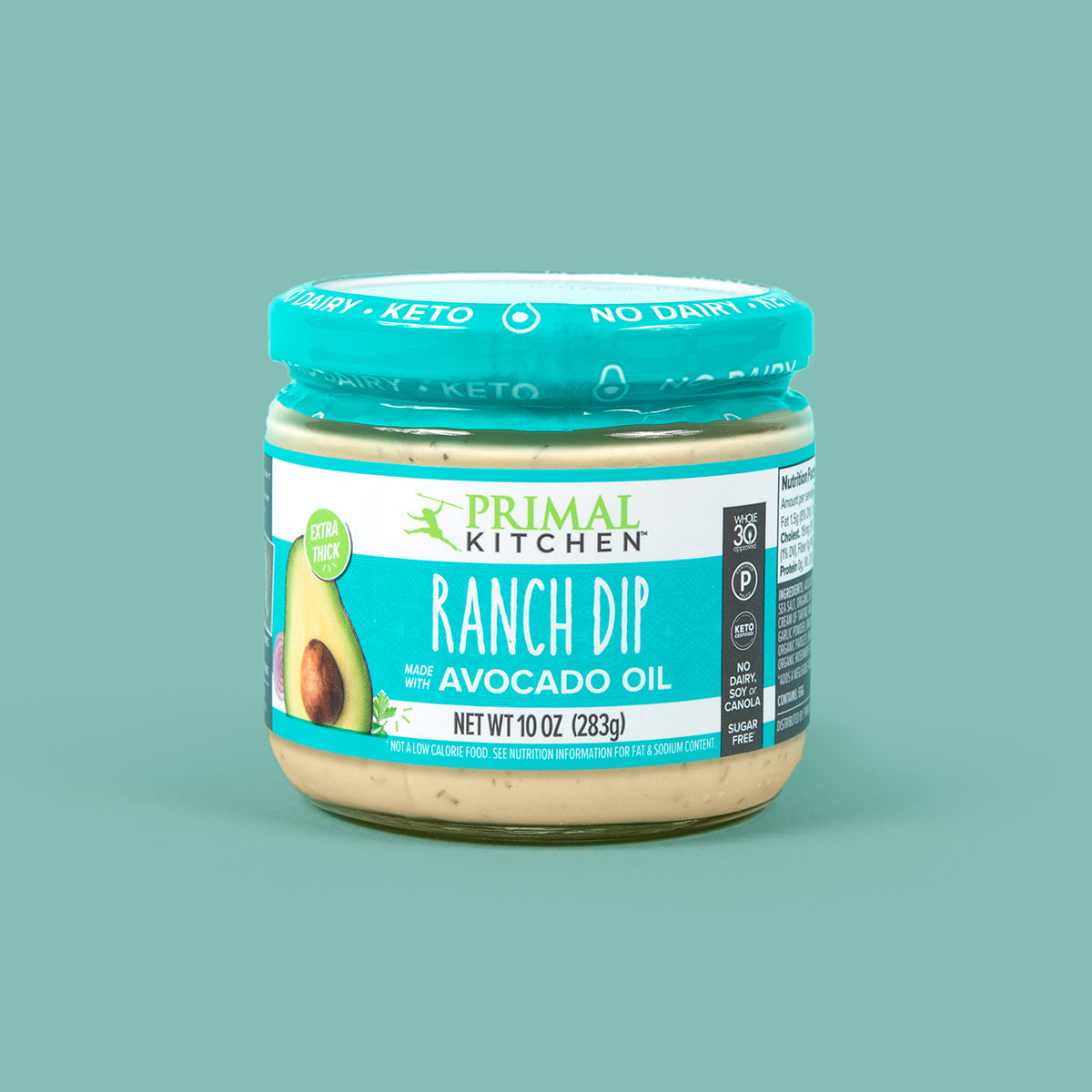 A jar of Primal Kitchen Ranch Dip made with avocado oil on a blue background. 