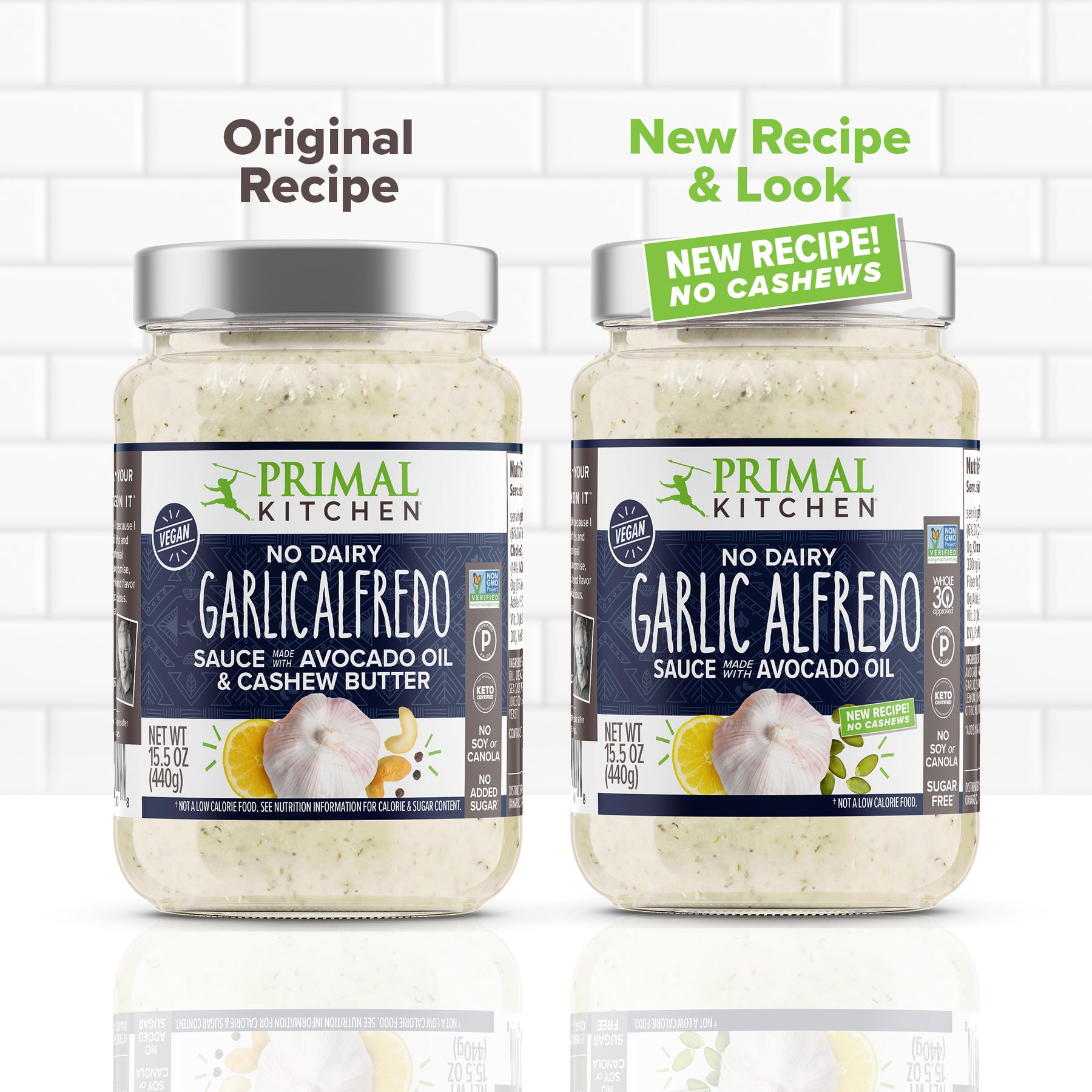 Two jars of Primal Kitchen Vegan No Dairy Garlic Alfredo Sauce. One jar is the original recipe made with cashew butter and the other is the new recipe without cashews. 