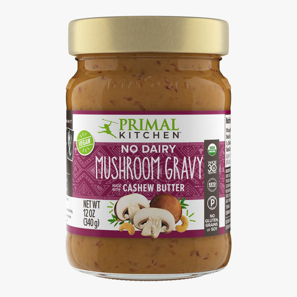 A jar of Primal Kitchen No Dairy Mushroom Gravy made with Cashew Butter with a dark purple label on a light grey background.