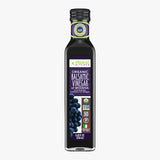A bottle of Primal Kitchen Organic Balsamic Vinegar of Modena with a dark purple label on a light grey background. 