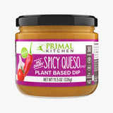 Front of a jar of Primal Kitchen Vegan No Dairy Spicy Queso Style Plant Based Dip with a dark purple label on a light grey background.