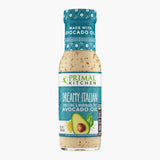A bottle of Primal Kitchen Dreamy Italian Dressing and Marinade made with avocado oil, with a turquoise label, on a light grey background.