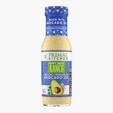 A bottle of Primal Kitchen Plant Based Ranch Dressing and Marinade made with avocado oil, with a purple-blue label, on a light grey background.