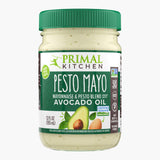 A 12 oz glass jar with a green lid of Primal Kitchen Pesto Mayo made with Avocado Oil.