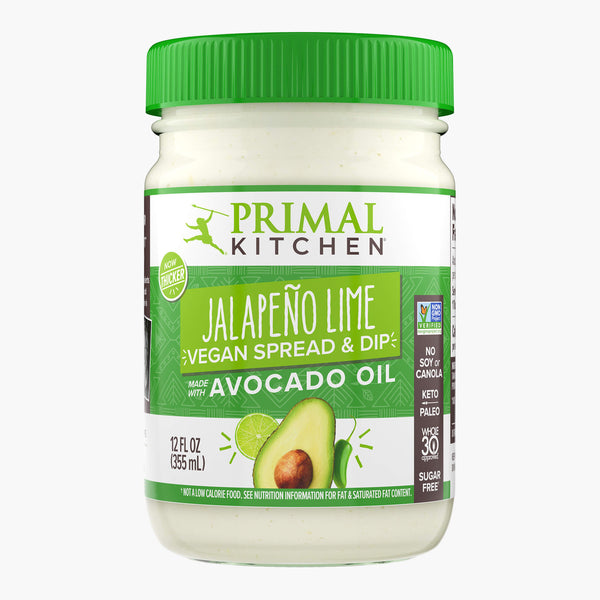 A 12oz glass bottle with a green lid of Primal Kitchen Jalapeno Lime Vegan Spread and Dip made with Avocado Oil.