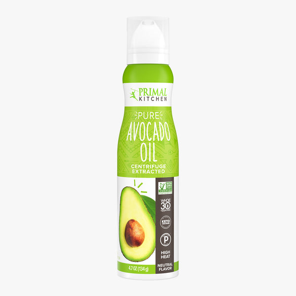 A bottle of Primal Kitchen Avocado Oil Spray with a bright green label on a light grey background.
