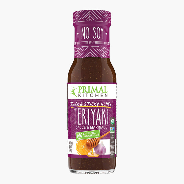 Bottle of Primal Kitchen No Soy Thick & Sticky Teriyaki Sauce & Marinade sweetened with honey on a white background