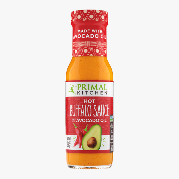 Bottle of Primal Kitchen Hot Buffalo Sauce made with Avocado Oil on white background